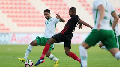 Emirates’ Abdulla Ali, left, and Al Ahli’s Saeed Ahmed, centre, battle for the ball during their Arabian Gulf League match in Dubai on Saturday. Christopher Pike / The National