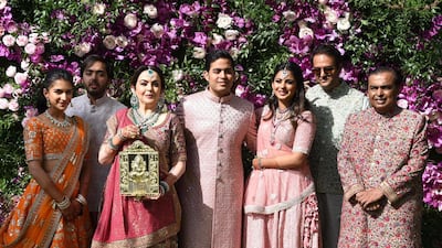 Akash Ambani (C), son of Indian businessman Mukesh Ambani (R) and businesswoman Nita Ambani (3rd L), their daughter Isha Ambani (3rd R) and her new husband Anand Piramal (2nd R), son of Indian billionaire industrialist Ajay Piramal (not pictured), pose during the wedding ceremony of Akash Ambani in Mumbai on March 9, 2019. Photo: AFP