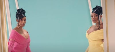 Cardi B, left, and Megan Thee Stallion wore co-ordinating Nicola Jebran one-pieces in their music video for 'WAP'. YouTube