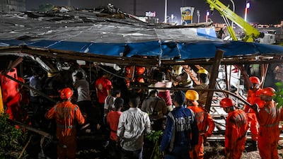 Rescuers look for survivors underneath the collapsed structure. AFP