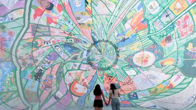 LONDON, ENGLAND - AUGUST 15: Twins Gonul Ali and Goode Ali attend the inaugural flight of major new artwork "Fields of EveryWhen", a spectacular 25 meter high hot air balloon celebrating the people and places of Thamesmead, by artists musson+retallick, winners of the Thamesmead Open, an international art competition, organised by Peabody at Southmere Square on August 15, 2022 in London, England. The 25 metre high hot air balloon features over 200 artworks celebrating Thamesmead creating a spectacular exhibition in the sky. The balloon will fly 5 times over Thamesmead this summer including at the Thamesmead Festival on Saturday 20th of August. (Photo by John Phillips / Getty Images for Peabody)