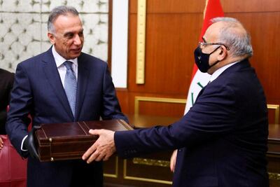 Former Iraqi Prime Minister Adel Abdul Mahdi hands over to new Prime Minister Mustafa Al Kadhimi in Baghdad. Iraqi Parliament Media Office