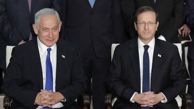 Israeli Prime Minister Benjamin Netanyahu, left, with President Isaac Herzog for the traditional group photo of the new government. EPA