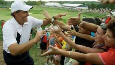 USA's Phil Mickelson is congratulated by the gallery after squeezing home by one hole in his fourball match.