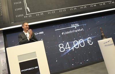 Oliver Blume, chief executive of Porsche, stands in front of a board displaying the chart of Germany's share index DAX during the launch of the IPO. AFP