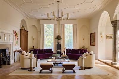 A living room at One Palace Green, featuring restored fireplace, grand arches, plus contemporary and historic art. Photo: Maison
