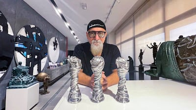 Iraqi sculptor Ahmed Al Bahrani with replicas of the Gulf Cup trophy he created. Photo: Ahmed Al Bahrani