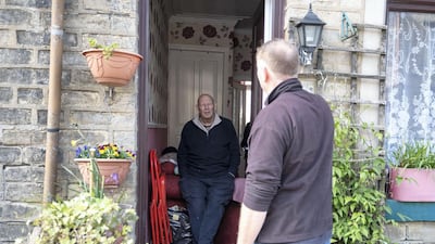 Kenneth Mitchell is visited by a friend whilst he self isolates in recovery, five weeks after contracting coronavirus in Bradford. Getty Images