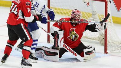 Ottawa Senators goaltender Robin Lehner watches as a puck flies by while teammate Mark Borowiecki, No 74, and Toronto Maple Leaf James van Riemsdyk, No 21, look on during the first period of an NHL game in Ottawa. Fred Chartrand / AP Photo