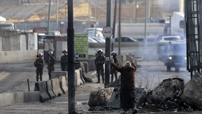 A man confronts Israeli forces after a demonstration demanding the return of bodies of Palestinians being held by Israel, at the Qalandia checkpoint south of Ramallah. AFP