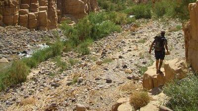A hiker negotiates the stony path on the nine-hour trail from Feynan.