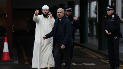 A man gestures as police officers are seen outside the London Central Mosque. Reuters