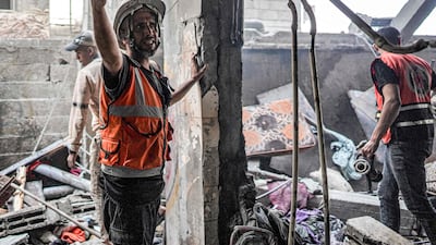 Rescue workers search a building following an Israeli bombardment in Nuseirat in the central Gaza Strip. AFP