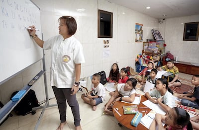 Young students from the the community nearby Wat Arun (Temple of Dawn) attend an English Class on Sunday morning. Sasamon Rattanalangkarn for The National