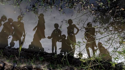 Children are reflected in the stagnant water, in Langic, Northern Bahr El Ghazal. This is the third consecutive year of extreme flooding in South Sudan.