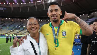 He cheered up as he posed with his mother Vera Lúcia Diniz de Jesus. Getty Images
