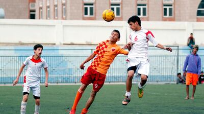 Yemeni youth take part in a football match as part of the local league in the capital Sanaa. Mohammed Huwais / AFP