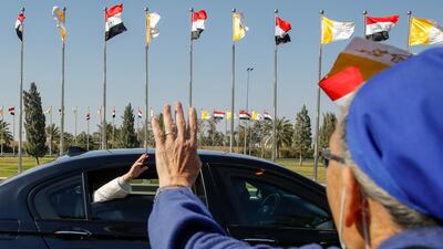 Pope Francis waves to the crowd upon his arrival in Baghdad. Reuters