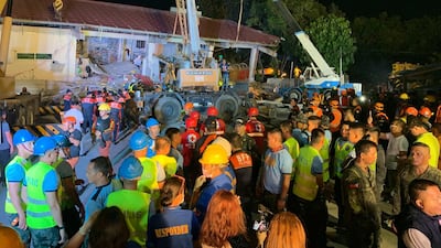 Rescuers search for people still trapped inside a collapsed building at Porac, Pampanga. A second earthquake struck central Philippines on April 23.