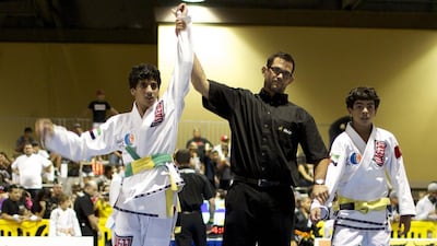 Abdulrahman Sultan Al Nuaimi has his hand raised as the winner in a match against his UAE Jiu-Jitsu teammate Mansour Al Ketbi in the gold-medal match on Saturday at the American National Kids Championship jiu-jitsu tournament in Long Beach, California. Zachary Patton for The National / October 18, 2014