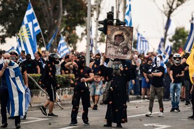 Protesters hold Greek flags and an icon during a demonstration against the agreement reached by Greece and Macedonia. AFP Photo
