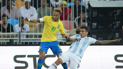 Brazil forward Neymar, left, and Argentina's Angel Correa compete for the ball during a friendly at King Abdullah Stadium. AP Photo