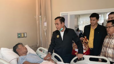 Thai Prime Minister Prayut Chan-o-cha (C) visiting a person injured during a mass shooting at the Terminal 21 shopping mall; at a hospital in Nakhon Ratchasima, Thailand. EPA