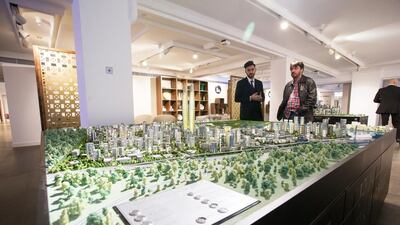 Visitors take a look at the Dubai Creek Harbour model. Courtesy Emaar / Harrods Estates