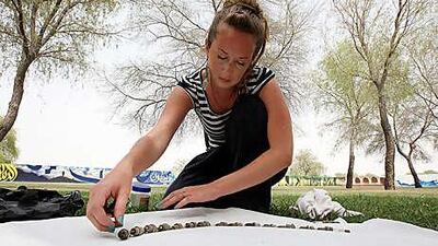 Rebecca Rendell assembling a new art piece with used spark plugs at Tashkeel Studios in Dubai.