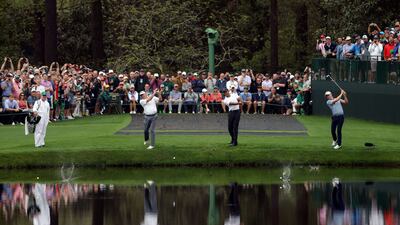 Fred Couples, Tiger Woods and Justin Thomas skip balls across the lake on the 16th hole. AFP