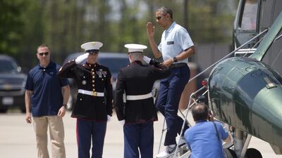 President Barack Obama salutes as he steps off of Marine One, in Andrews Air Force Base, as he returns from the presidential retreat at Camp David. Carolyn Kaster / AP Photo