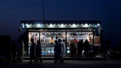 Summer sale: devotees pass a shop selling strings of prayer beads, caps and traditional shawls at the shrine of Sufi Saint Shah Rukn-e-Alam in Multan, Pakistan. Mian Khursheed / Reuters