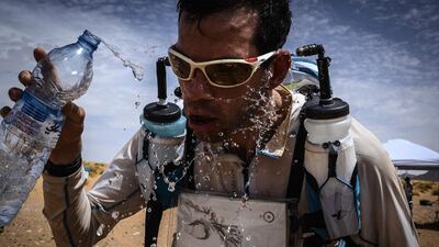 A competitor splashes water on his face during the Marathon des Sables in the Moroccan Sahara desert. AFP