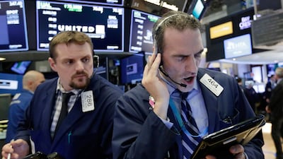 Traders Michael Milano, left, and Gregory Rowe work on the floor of the New York Stock Exchange. The Dow dropped 3.68 per cent in March with volatility continuing this month. Richard Drew / AP