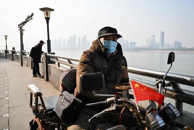 A motorcyclist next to the Yangtze River in Wuhan just before the fifth anniversary of China confirming its first death from Covid-19. AFP