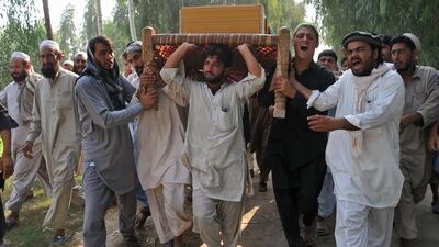 Afghan men carry the coffin of a civilian, allegedly killed in a Nato air strike, on the outskirts of Jalalabad in Nangarhar province on October 5, 2013. AFP Photo/ Noorullah Shirzada