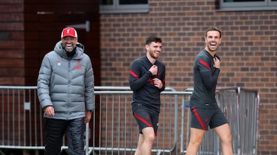 Jurgen Klopp laughing with Jordan Henderson and Andy Robertson. Getty