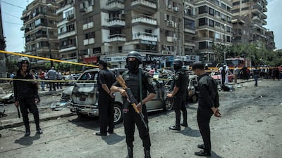 Egyptian policemen in 2015 stand guard at the site of a bombing that killed Egypt's top prosecutor, Hisham Barakat. AP
