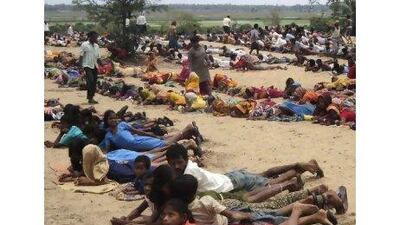 Villagers and their children lie at the proposed site of a $12bn steel plant by South Korea's Posco during a protest in the eastern Indian state of Orissa. REUTERS / Stringer