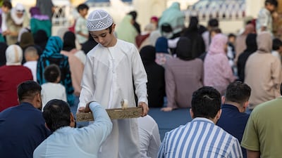 Worshippers gather at Al Farooq Omar bin Al Khattab Mosque. Antonie Robertson / The National
