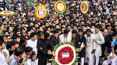 People lay flowers at the Bangladesh Central Language Martyrs' Memorial in Dhaka, in homage to students that were killed during the Bengali language movement demonstrations of 1952. AFP