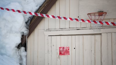 A red-tagged garage underneath piles of pillowy snow. EPA