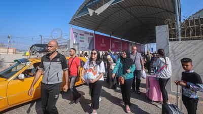 Palestinians with dual citizenship pass through the Rafah border crossing from Gaza into Egypt on Wednesday. Bloomberg