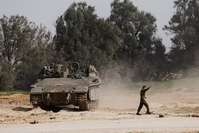 An Israeli soldier directs a tank close to the southern part of the Gaza Strip, near the Karam Abu Salem crossing. Reuters