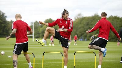 Wales’ Gareth Bale, centre, stretches during a training on Wednesday. John Sibley / Reuters