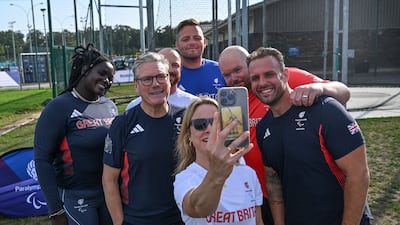 Mr Starmer poses for selfies with British athletes during a visit to a training centre during the Olympic Games in Paris, in August