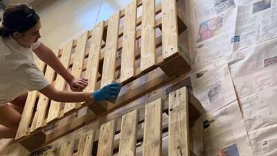 Step one - sanding down the pallets, which cost Dh20 each. Photo by Samantha Hall