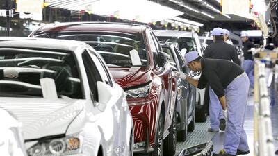 Assembly workers make paint inspection for the new sport utility vehicle Lexus NX, in red, and other Lexus vehicles. Kimimasa Mayama / EPA