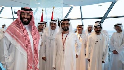 Mohammed bin Salman, the Saudi Crown Prince (L), Sheikh Mohammed bin Rashid, Vice President and Ruler of Dubai, Sheikh Khalifa bin Tahnoon bin Mohamed Al Nahyan, Director of the Martyrs' Families' Affairs Office of the Abu Dhabi Crown Prince Court (2nd L) and other dignitaries, attend the final day of the 2018 Formula 1 Etihad Airways Abu Dhabi Grand Prix, in Shams Tower. Ryan Carter / Ministry of Presidential Affairs
