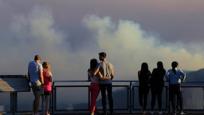 People watch as smoke from the Green Wattle Creek fire is seen from Echo Point lookout in Katoomba, as bushfires continue to blaze in New South Wales, Australia. Reuters